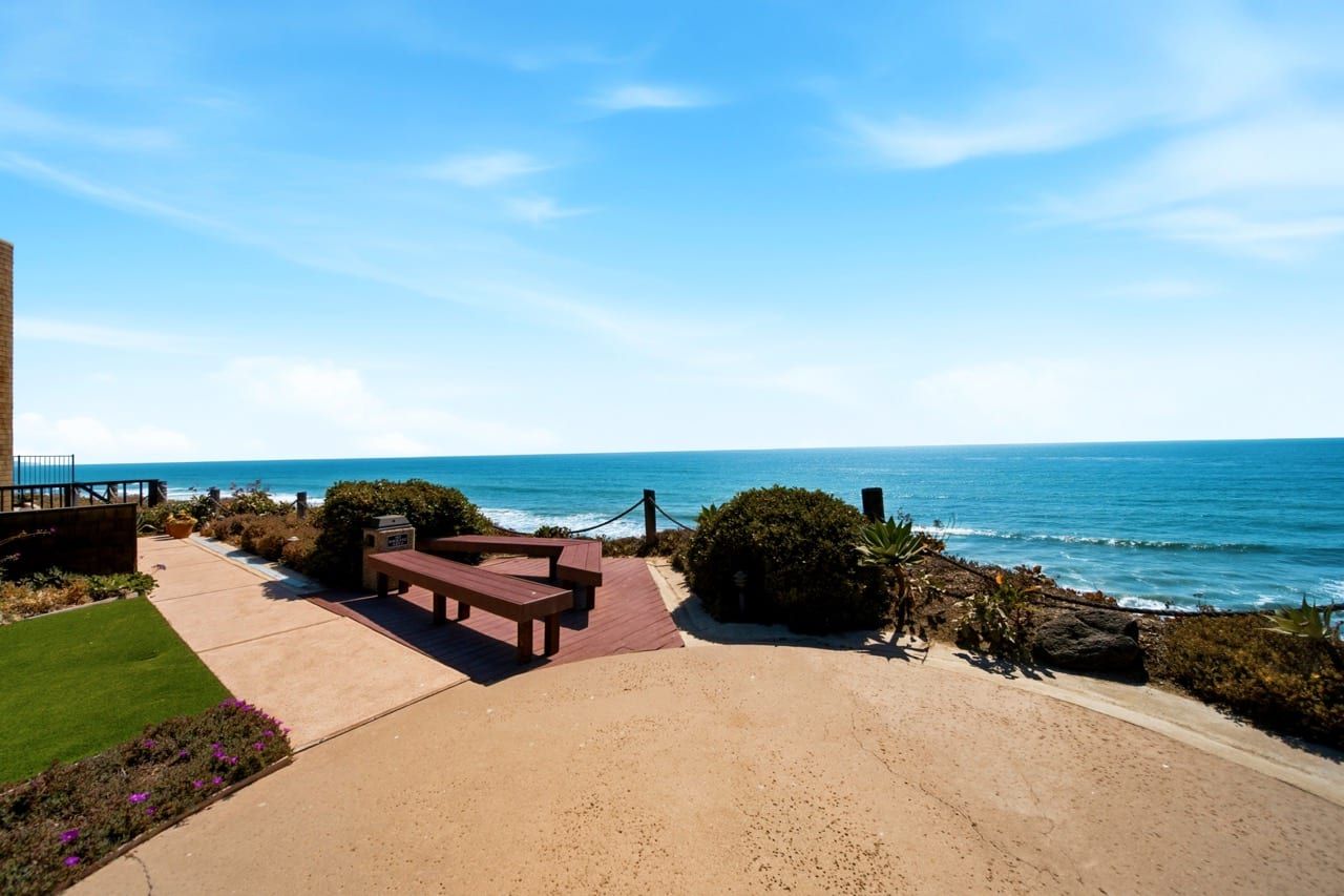 Benches set at the bluff edge, looking out over the water