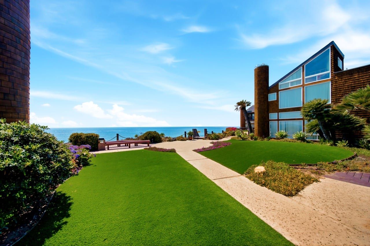 Lawn running to the bluff edge with the ocean beyond