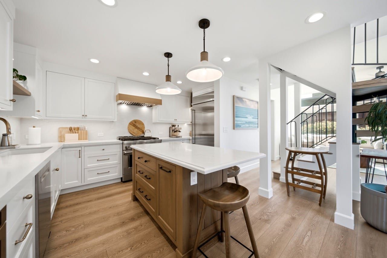 The kitchen, with an oak island, quartz counters and a professional gas range