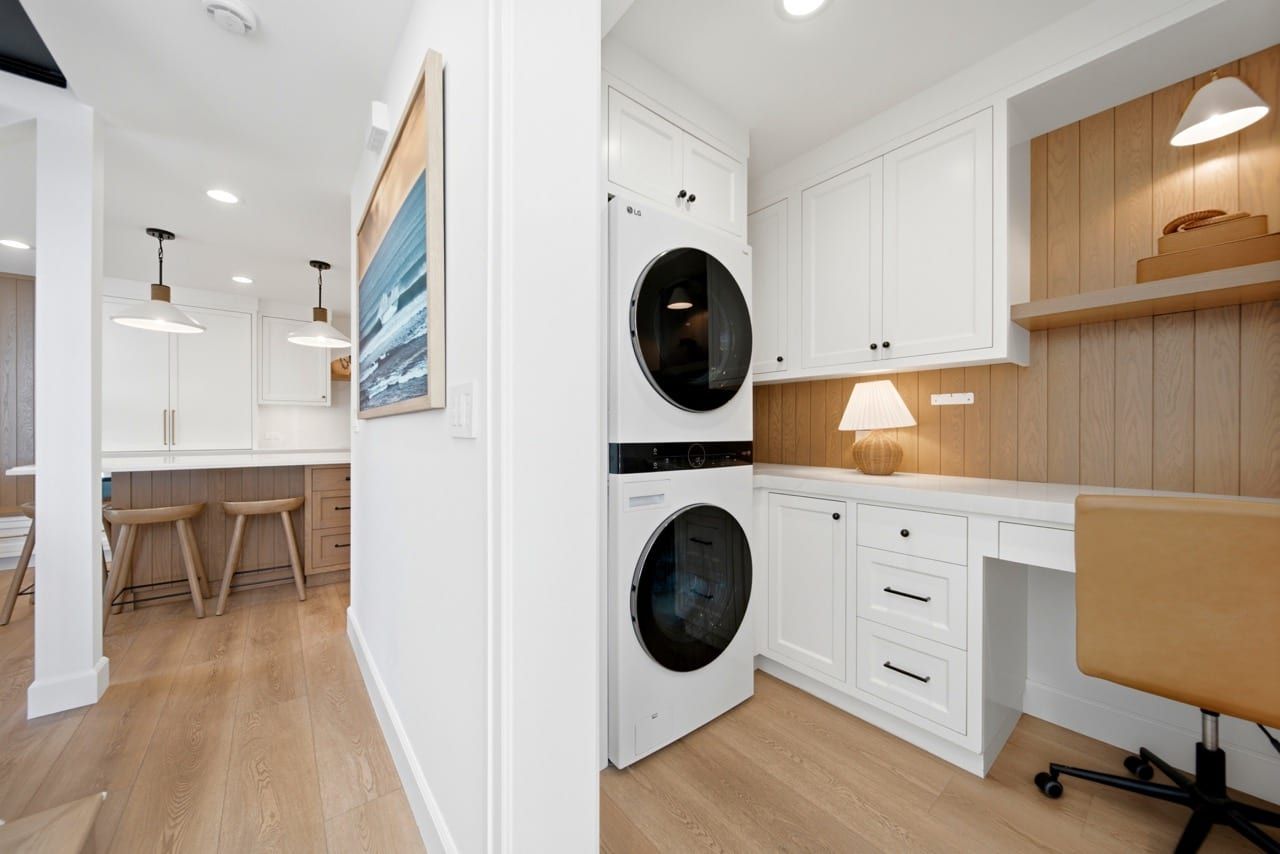 The utility room and desk nook, with the kitchen visible beyond