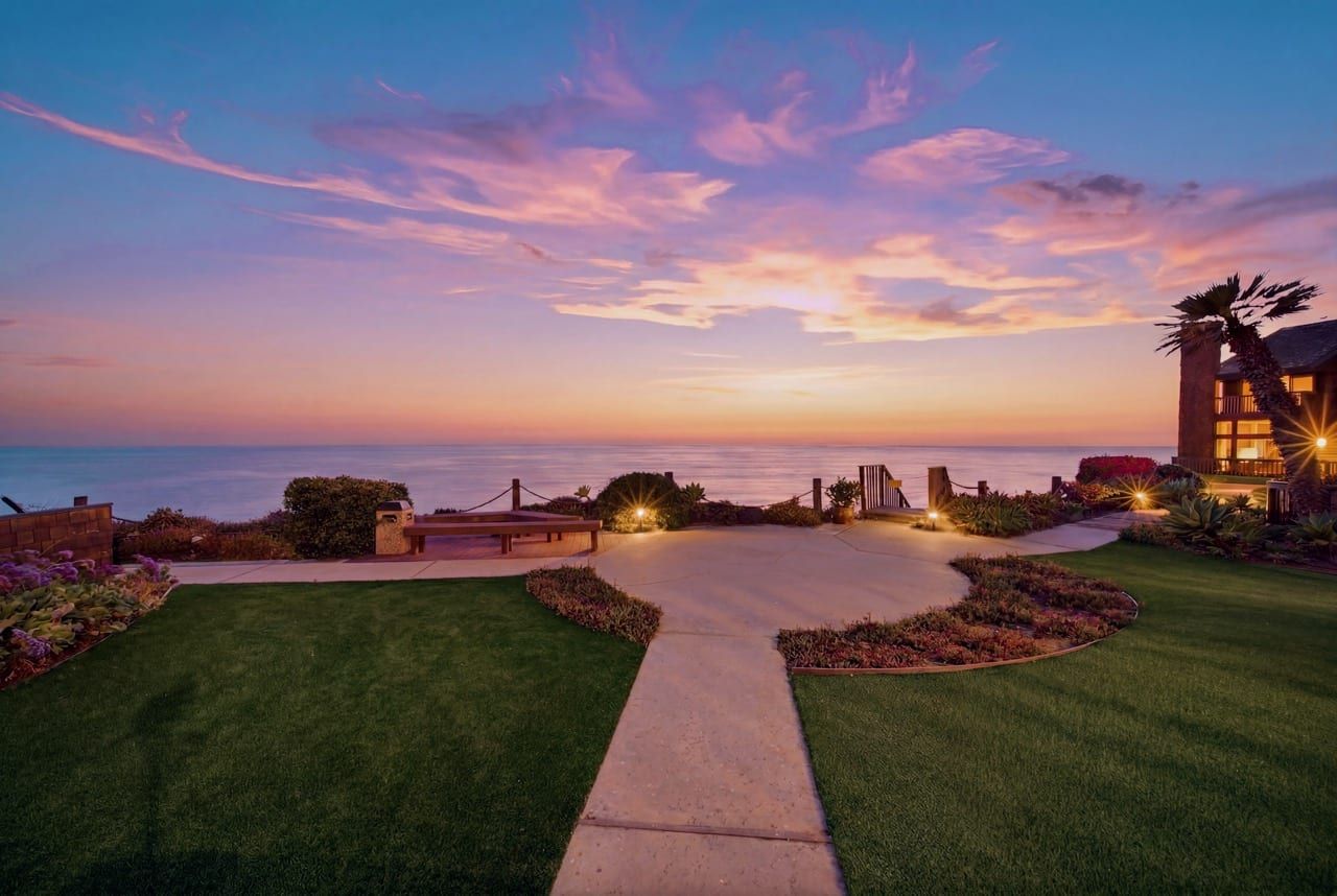 The community lawn at sunset, the sky pink over the Pacific