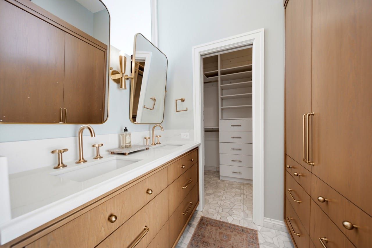 The primary vanity beside the fitted walk-in closet
