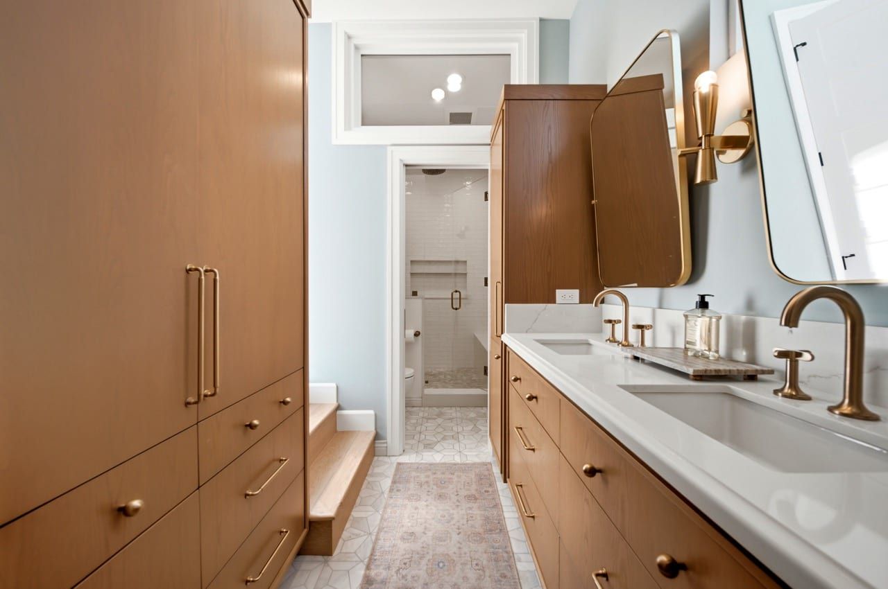 The primary bathroom, with a double oak vanity and brass fittings
