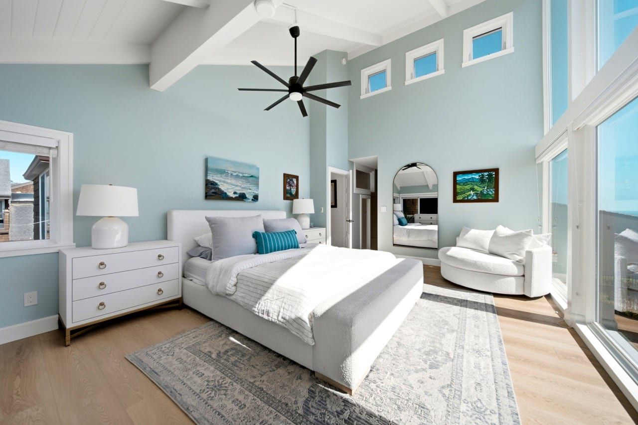 The primary bedroom looking toward its sitting area under the vaulted ceiling
