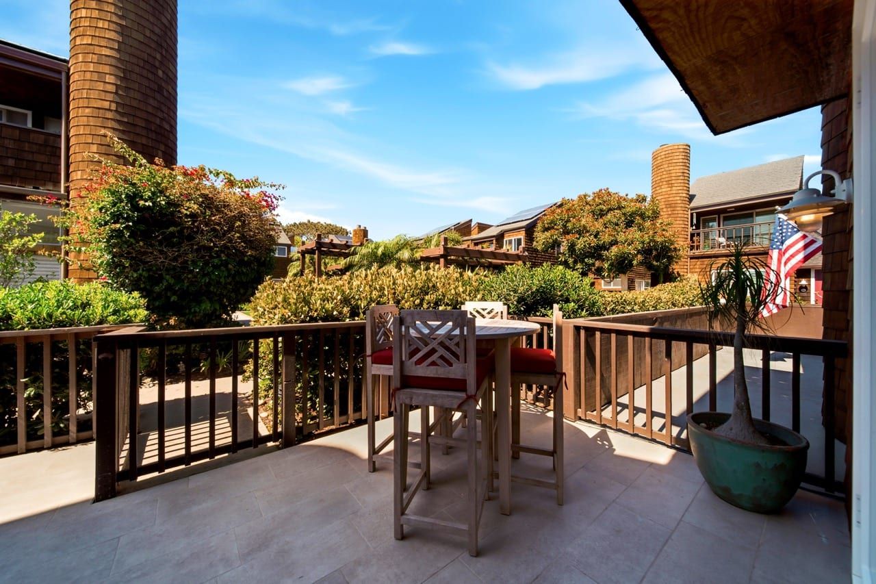 The private deck, with a table and stools among the planting