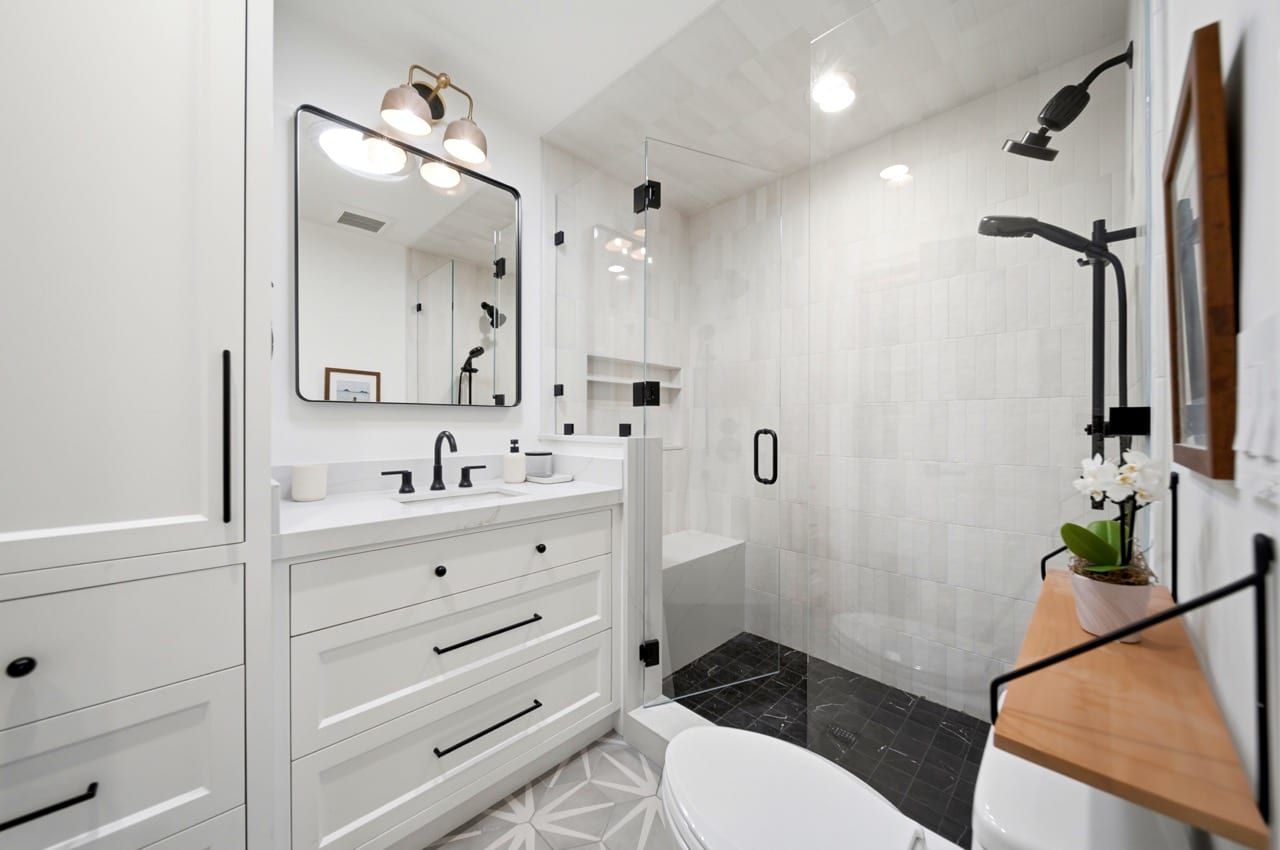 The second bathroom, with a walk-in shower and patterned tile floor